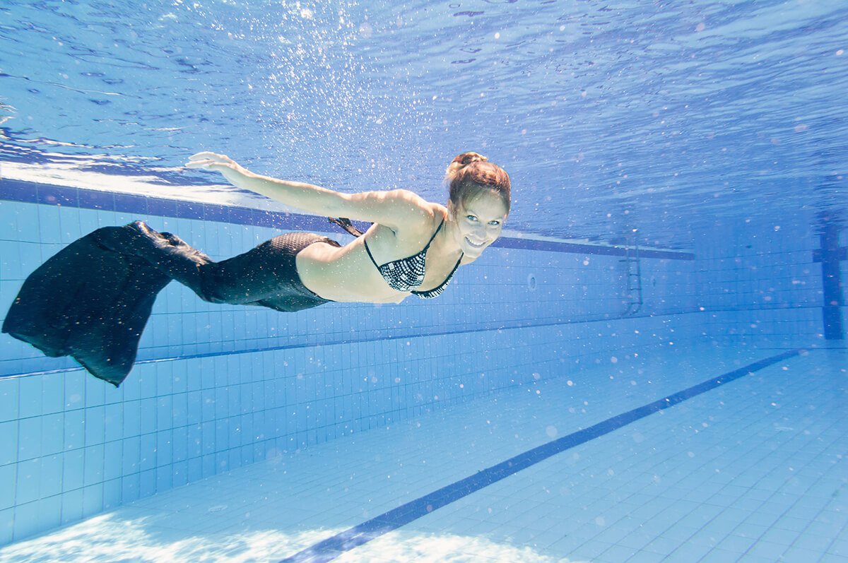 adult mermaid woman in pool
