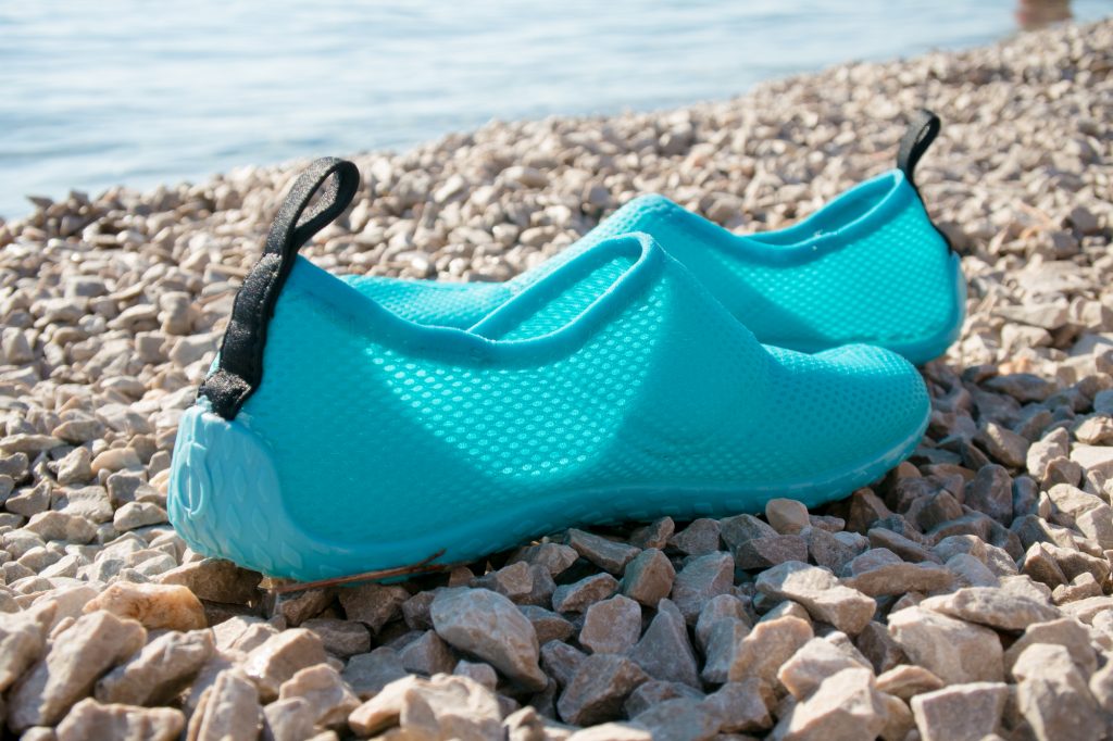 water shoes on stones at the ocean