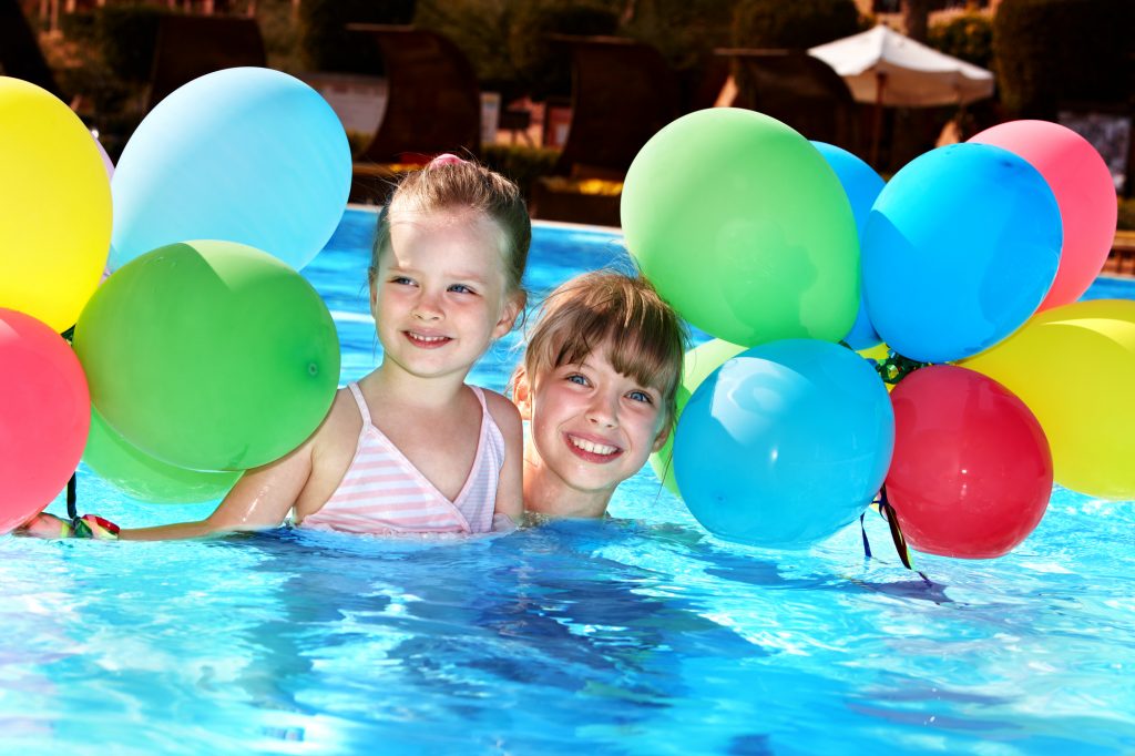 girls in pool with balloons