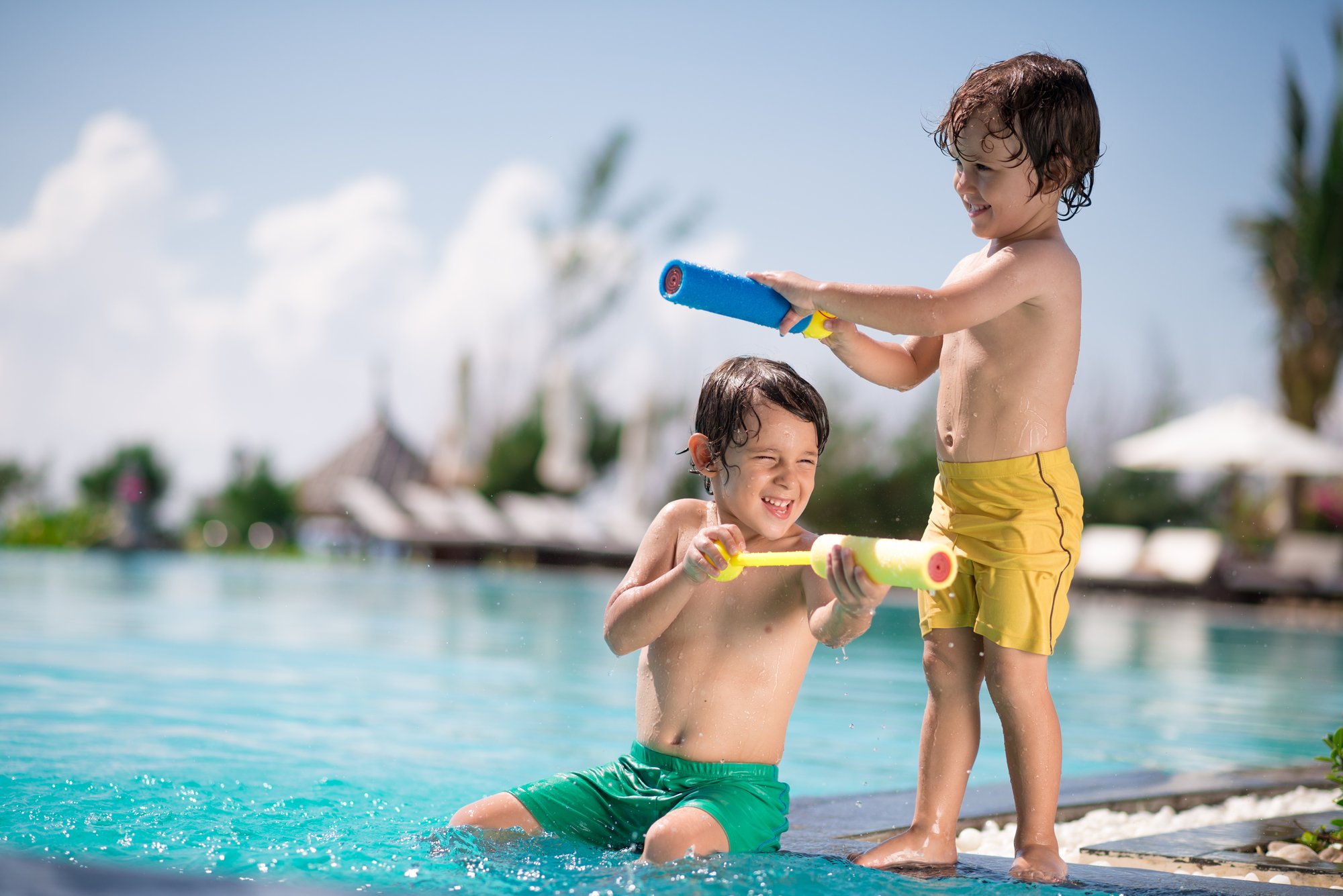 two boys playing at the pool