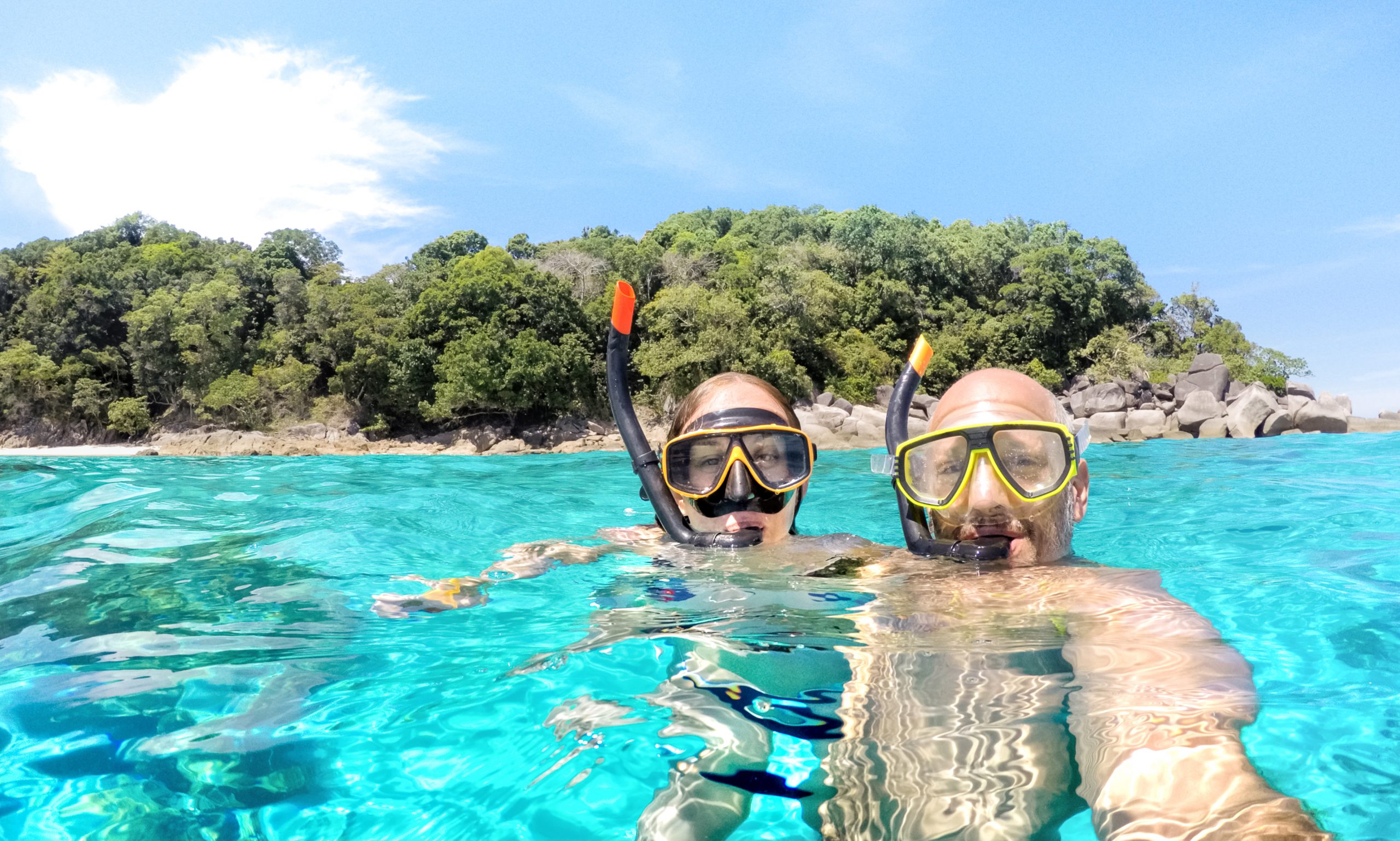 couple with snorkling set in the ocean
