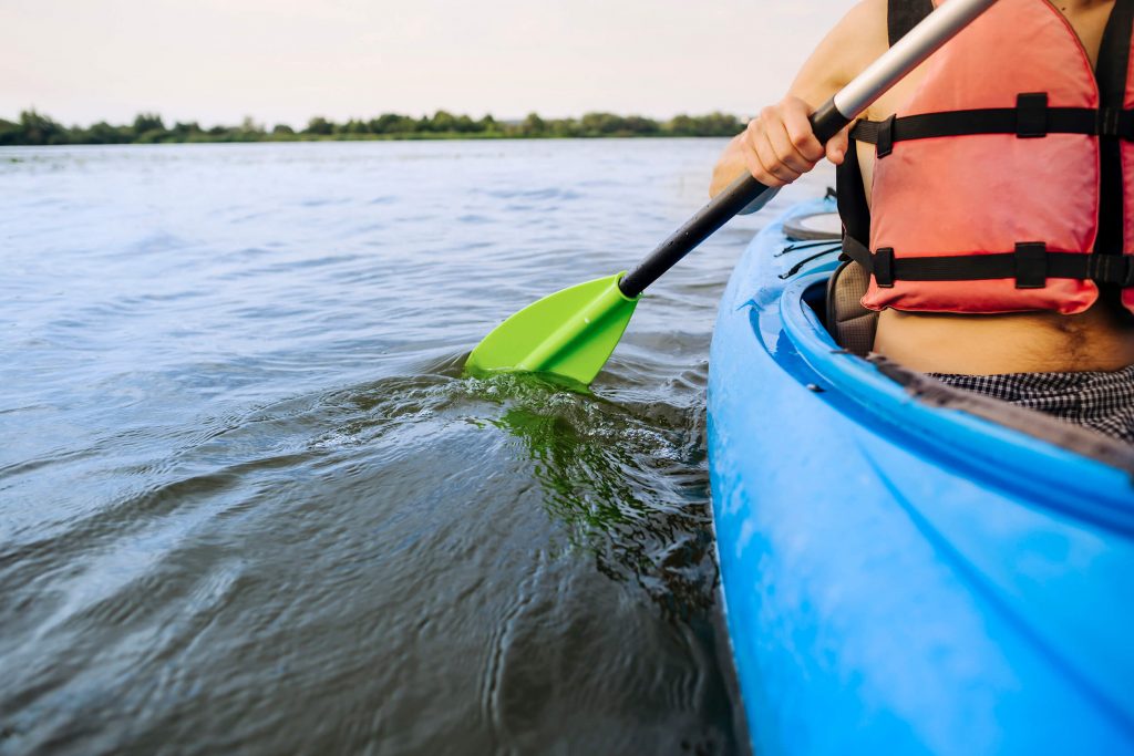 man paddling kayak