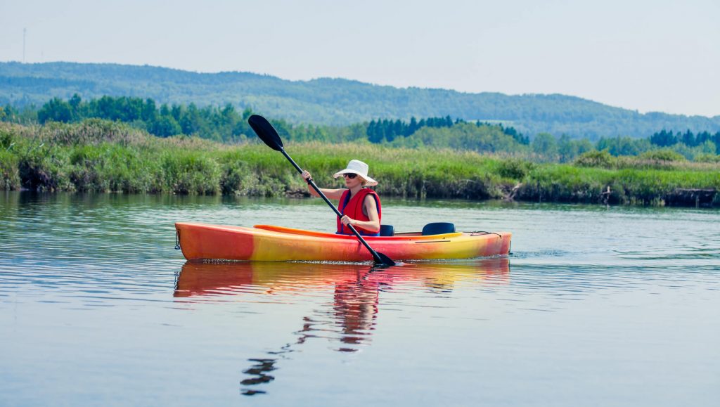 woman with hat kayaking