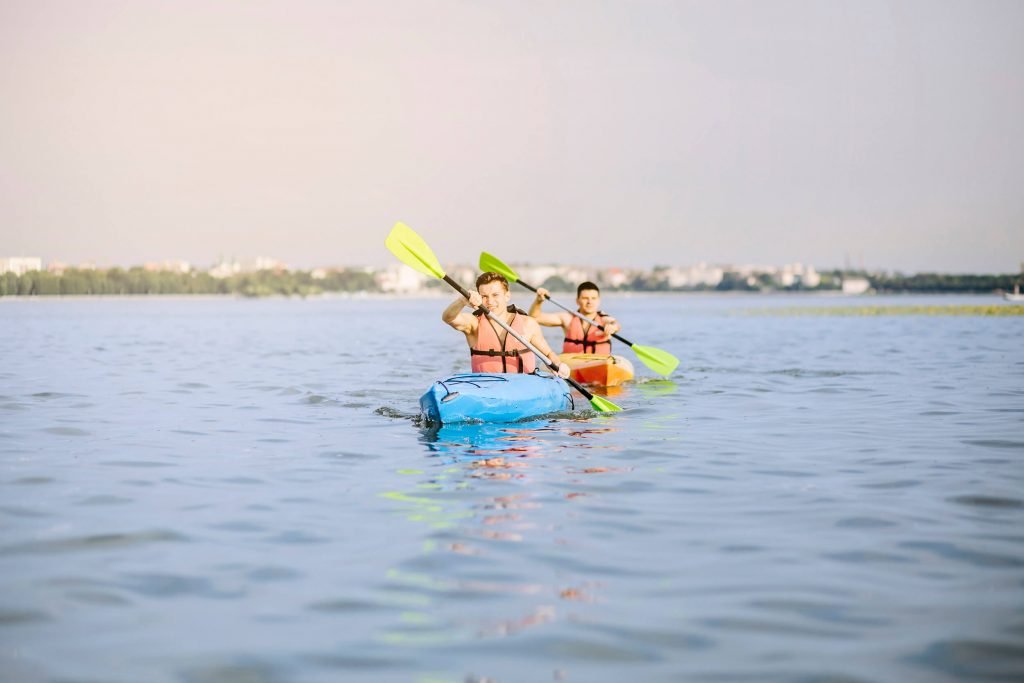 men kayaking on lake