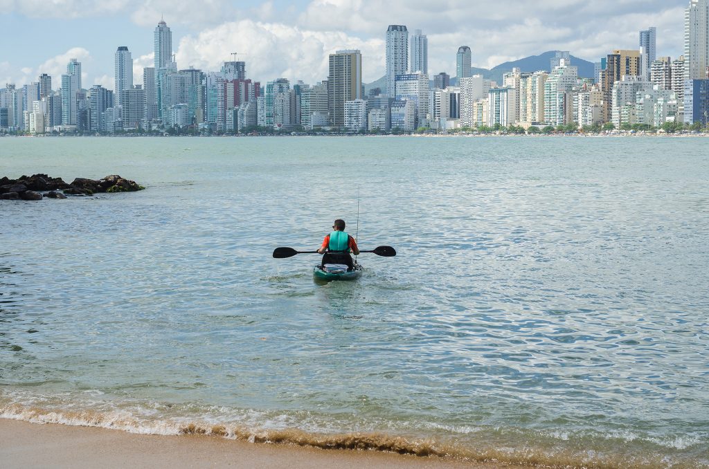 Kayaker in front of big city