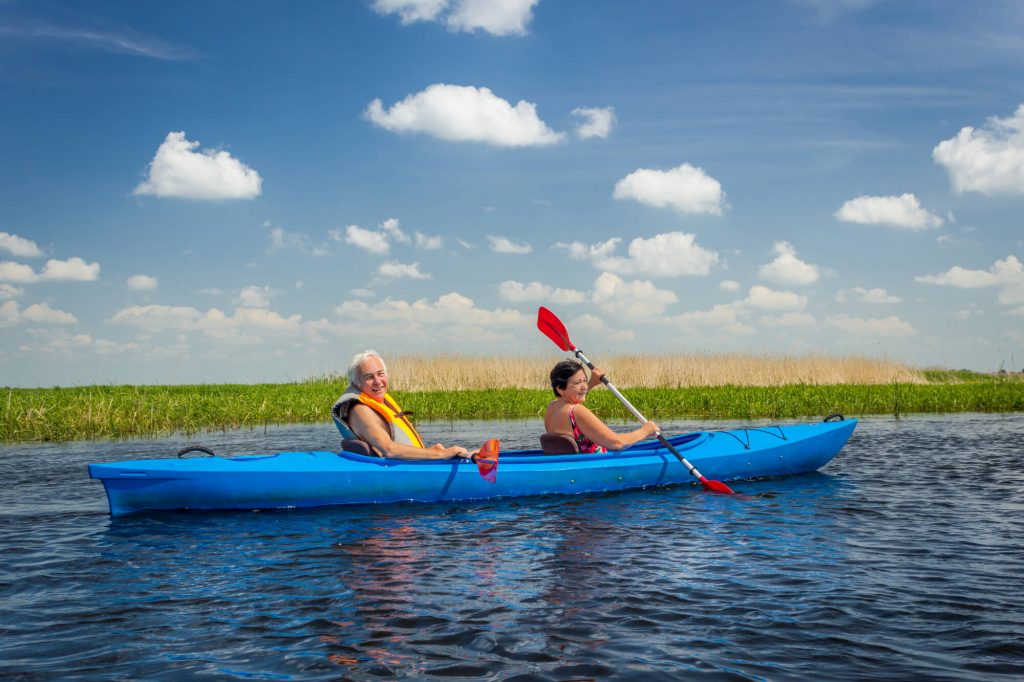 elderly couple in tandem kayak