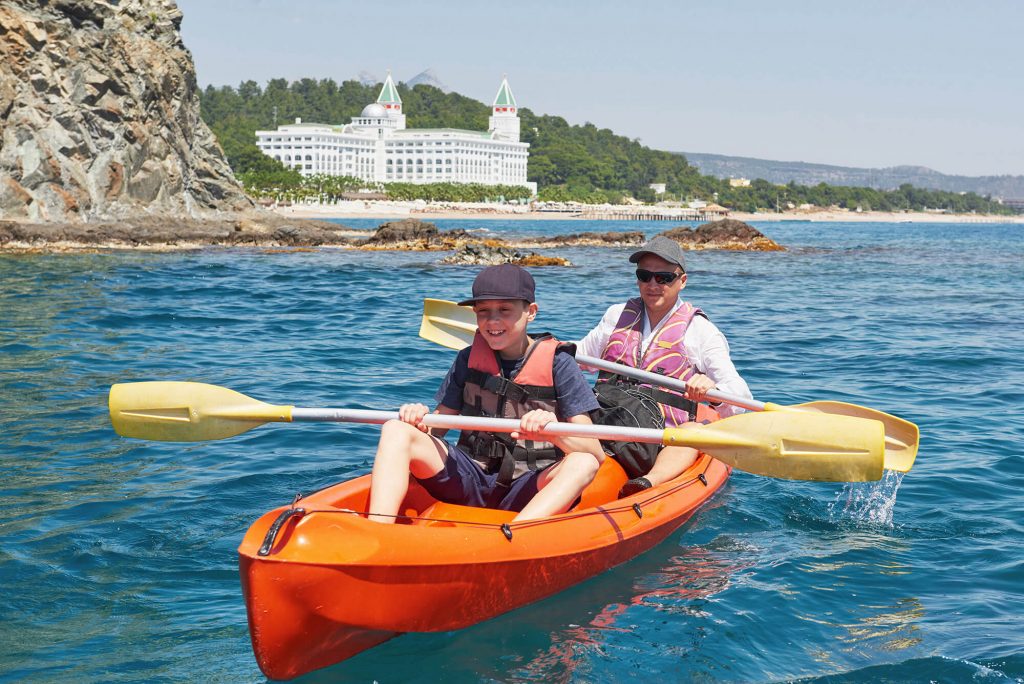 father and son in tandem kayak