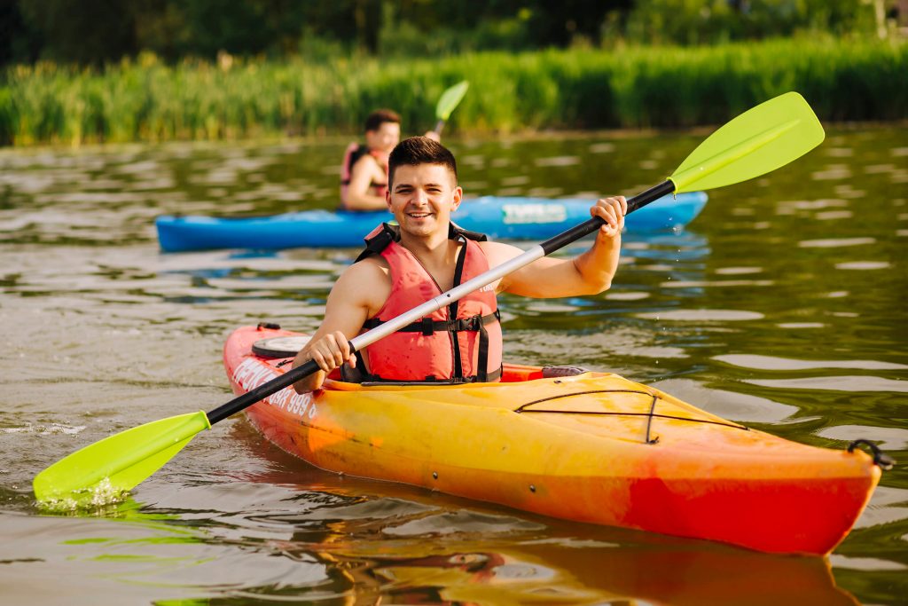 man paddling in kayak