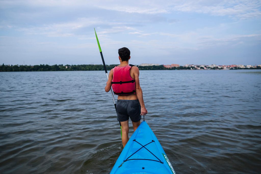 man pulling kayak