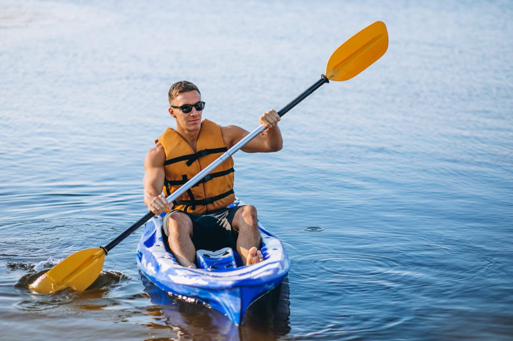 man with life vest on kayak