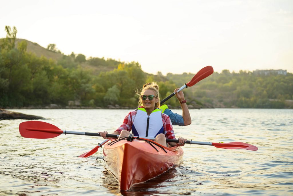 couple with sunglasses kayaking