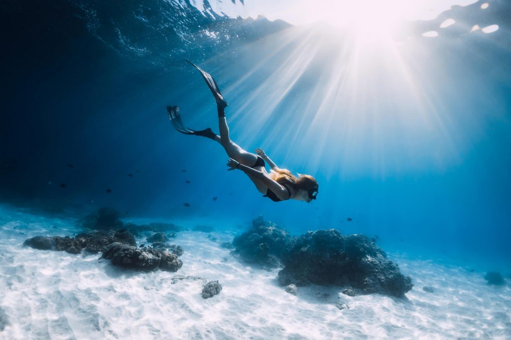 woman snorkeling in clear water