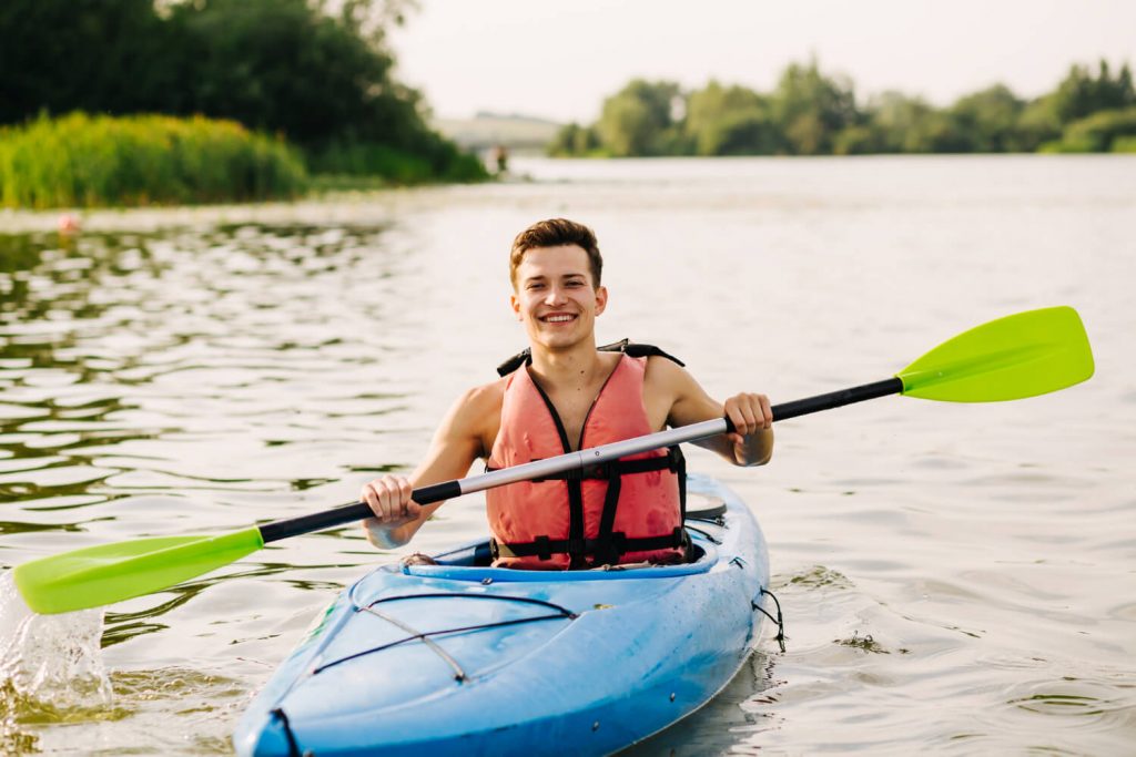 man paddling in kayak